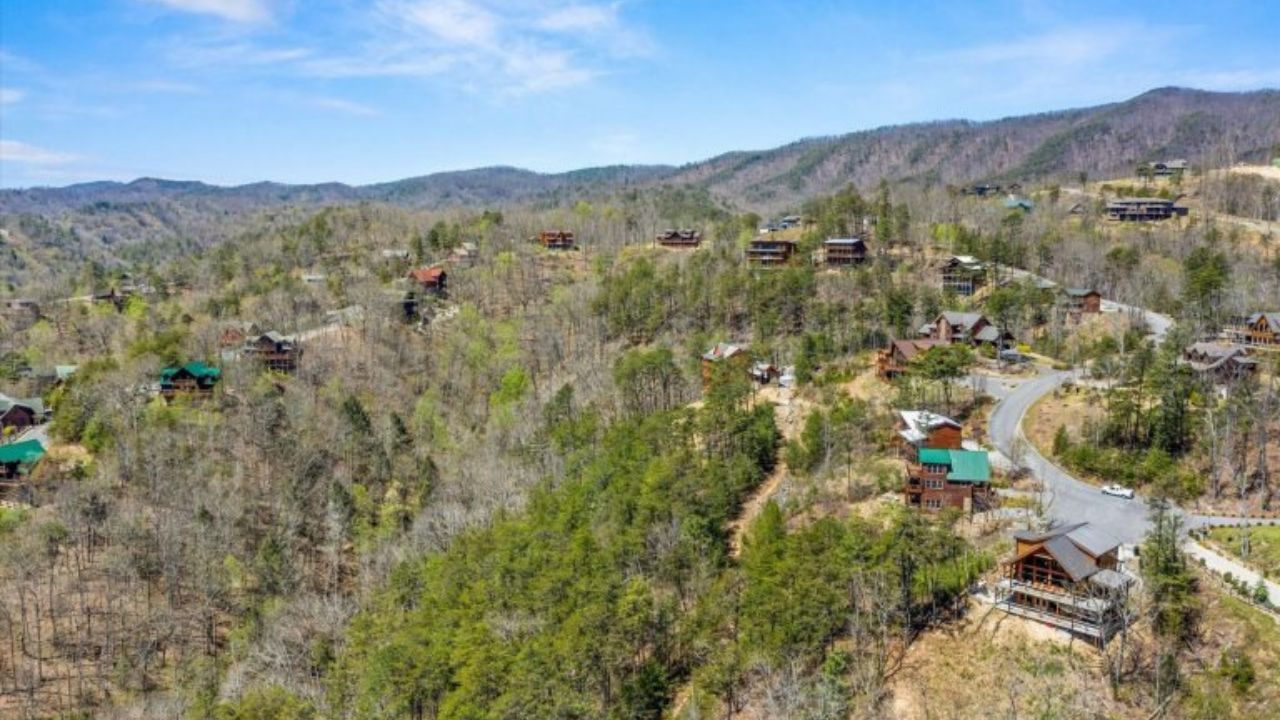 7 Log Cabins in Tennessee You Should Rent A traditional log cabin with a scenic view of the Smoky Mountains in Tennessee.