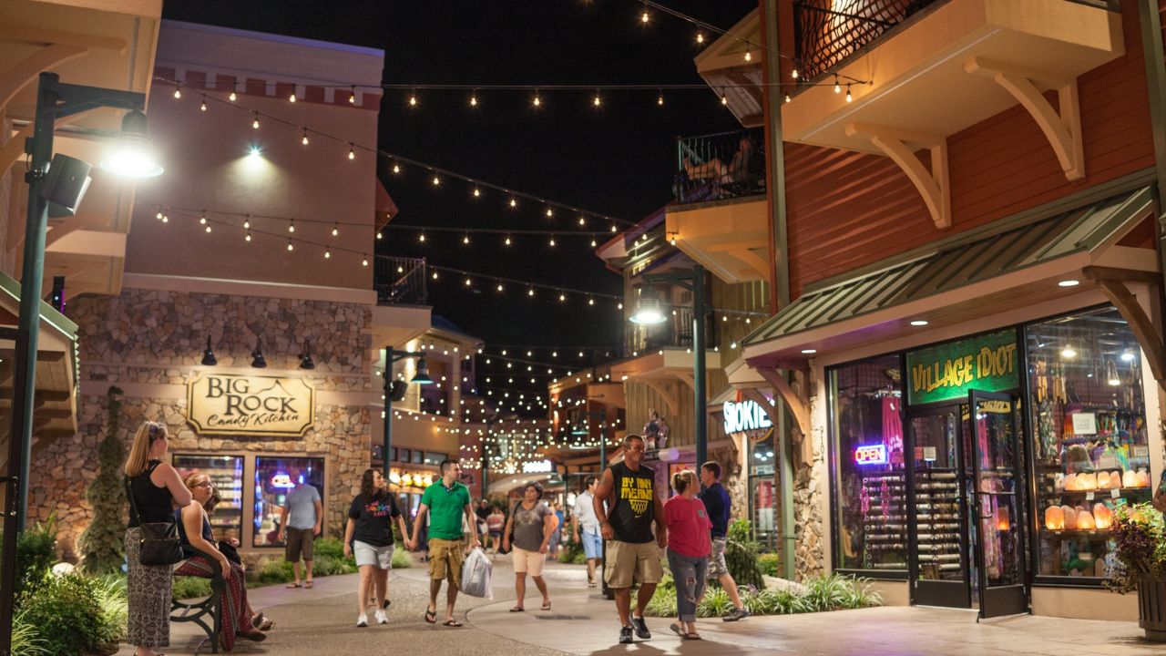 The charming ambiance of The Island at night, with people exploring shops and enjoying summer activities.