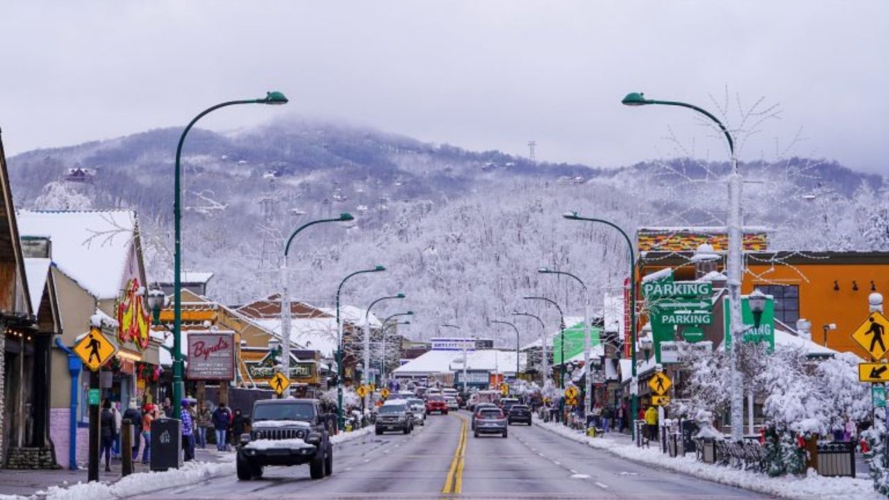 A picturesque view of Gatlinburg with snow-capped mountains in the background.